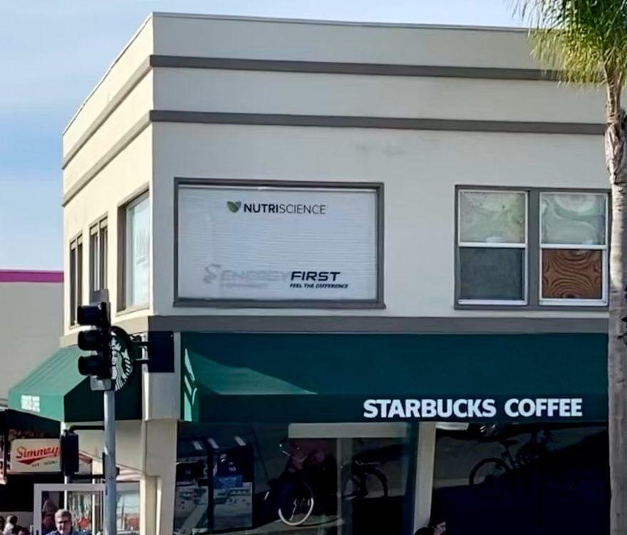 The NutriScience and EnergyFirst signs in the office windows on Highland Avenue in Manhattan Beach, above the corner Starbucks